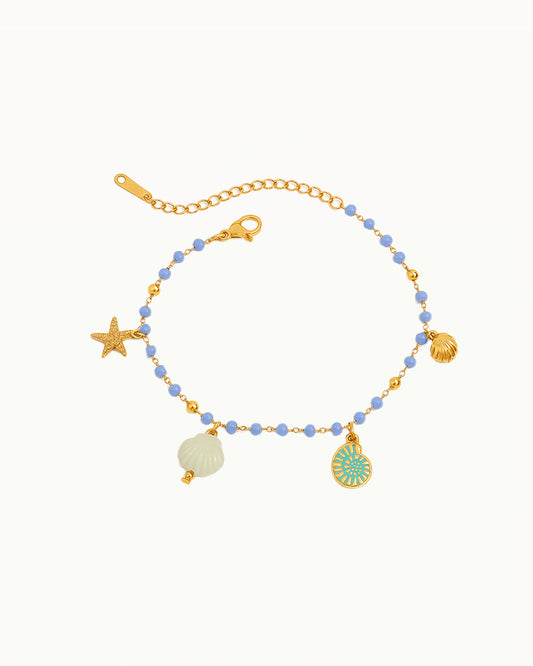 Bracelet en or avec perles bleues et breloques marines - Brigitta